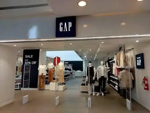 Interior of a Gap store with sale signage beneath a headline about a selective turnaround story